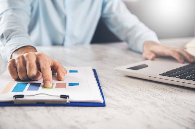 Man hand graph with keyboard on office desk