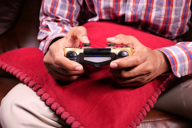 Man hand hold joystick playing games .