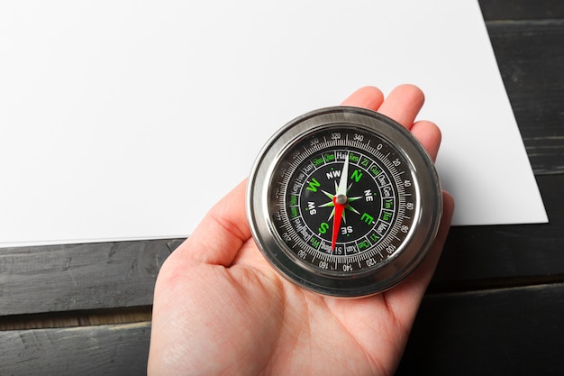 Man Hand Holding Chrome Compass