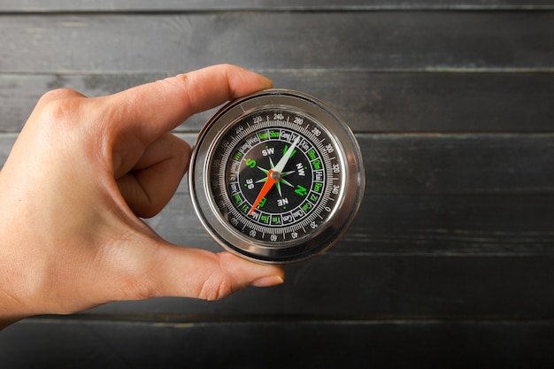 Man Hand Holding Chrome Compass