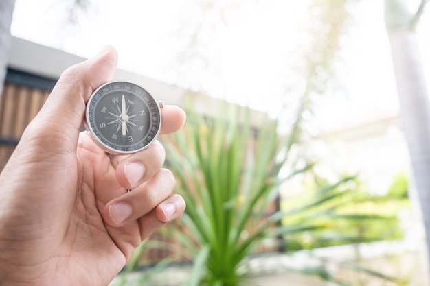 Man hand holding compass