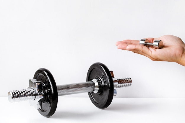 Man hand holding dumbbell Exercise for good health backdrop for idea concept art work design or add text message