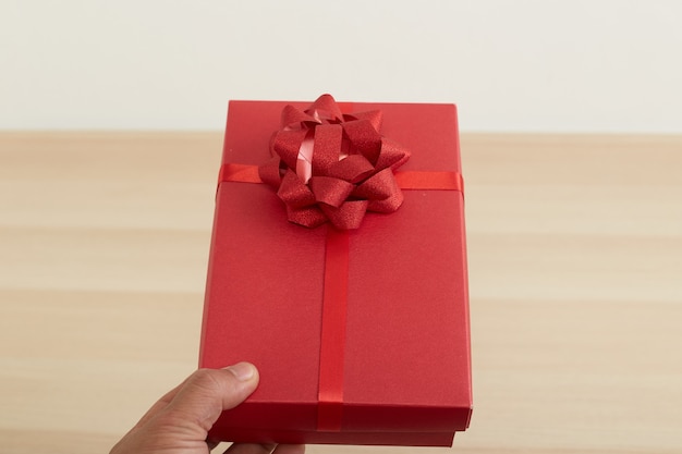 Man hand holding red gift box