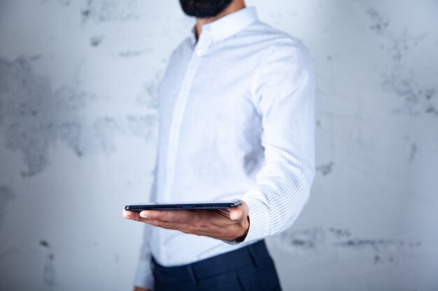 Man hand holding smart phone on white