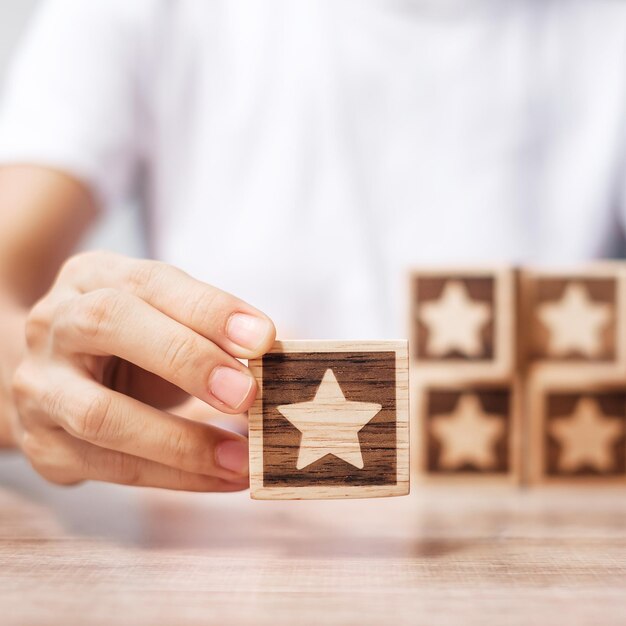 man hand holding star block customer choose rating for user reviews service rating ranking customer review satisfaction evaluation and feedback concept