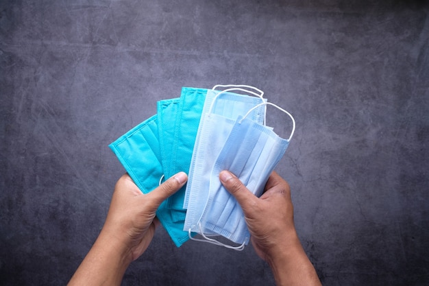 Man hand holding surgical face mask, close up ,