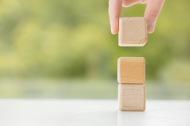 Man hand holding wooden blocks