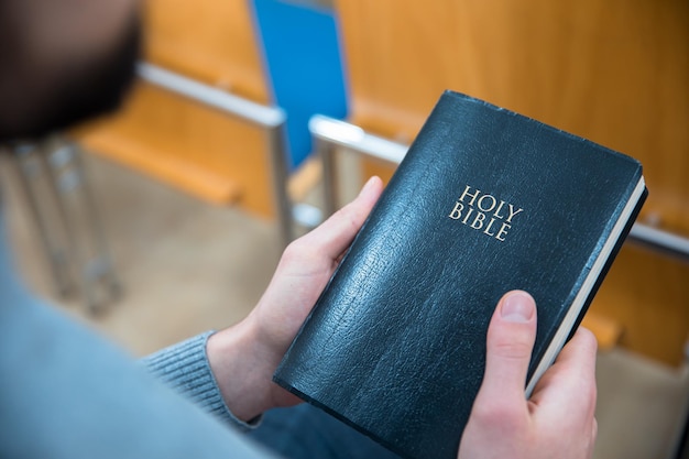 Man hand Holy Bible