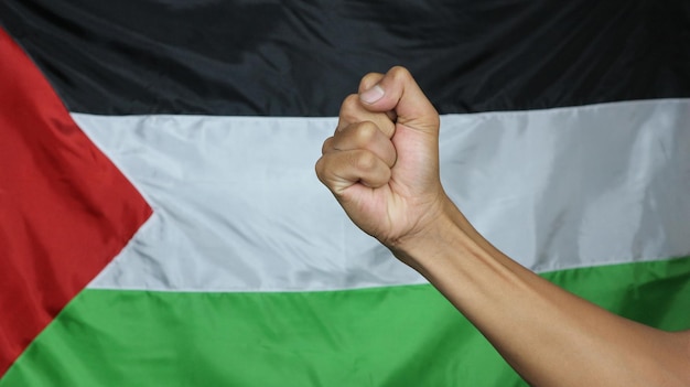 Photo man hand isolated on the background of the flag of palestine