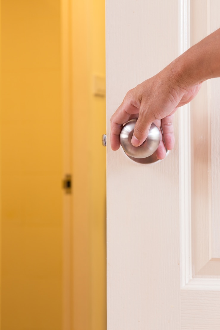Photo man hand locking door knob