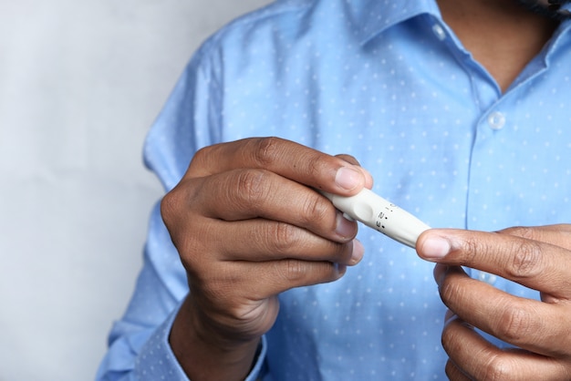 Photo man hand measuring diabetic glucose level at home