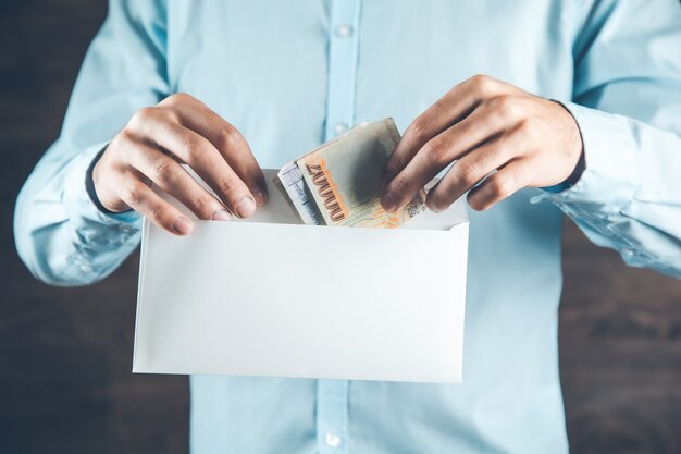 Foto man hand met geld met brief