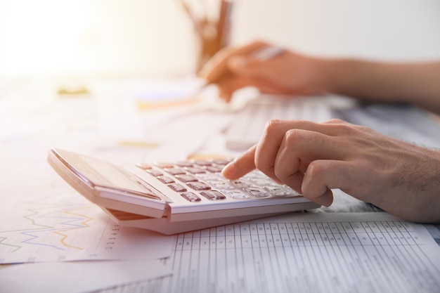 Man hand notepad with calculator