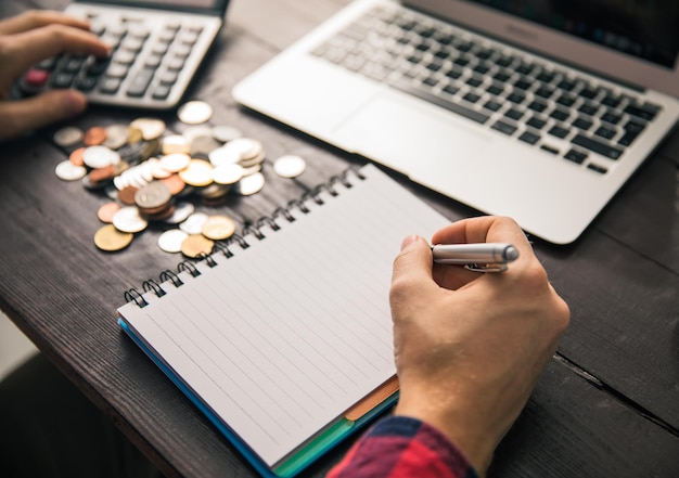 Man hand notepad with coins