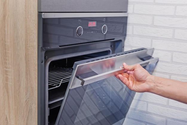 Man hand open electric oven