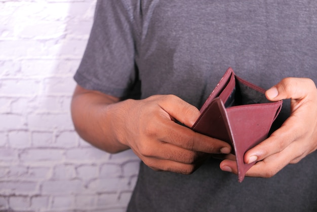 Man hand open an empty wallet with copy space.