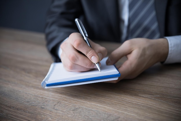 Man hand pen with notepad