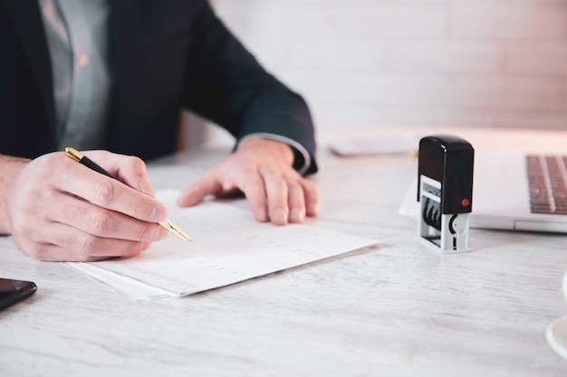 Man hand pen with seal and document