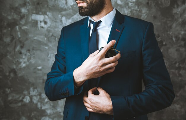 Man hand perfume on dark background