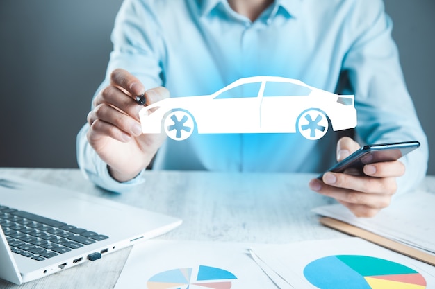 Man hand  phone and car in the screen