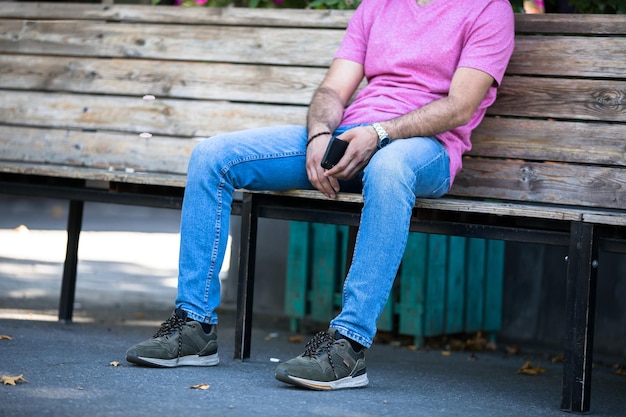 Man hand phone sitting in street