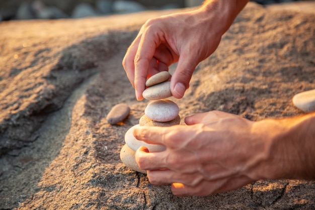 Man hand put stone building