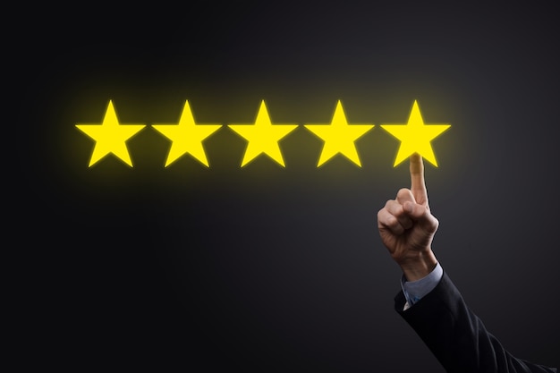 Photo man hand showing on five star excellent rating.pointing five star symbol to increase rating of company