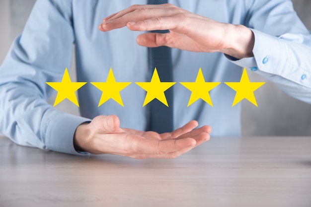 Man hand showing five star excellent rating.