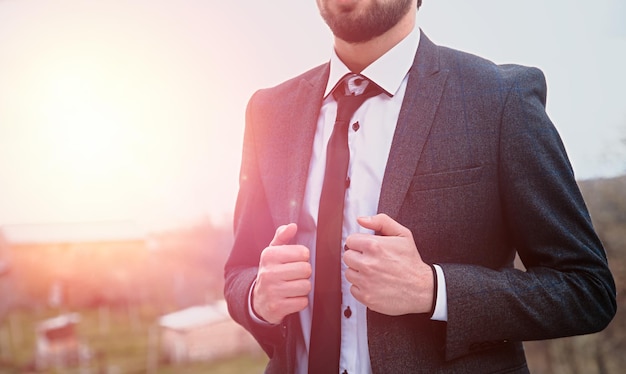 Man hand in suit in street