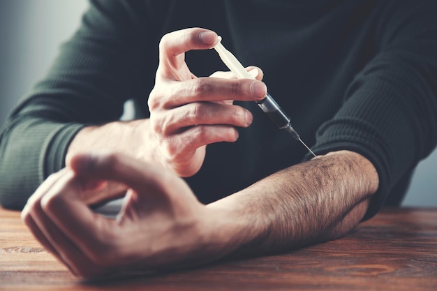 Man hand syringe