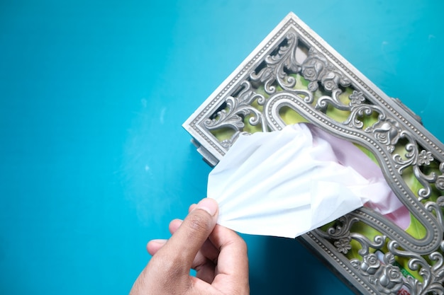 Man hand taking a tissue from a box.