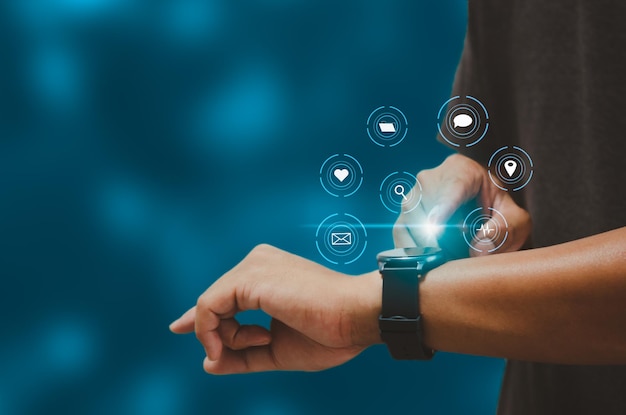 Man hand touching a smart watch virtual icon. Communication and use of modern Internet technology metaverse, Social Networking, online marketing, digital online. Concept technology.