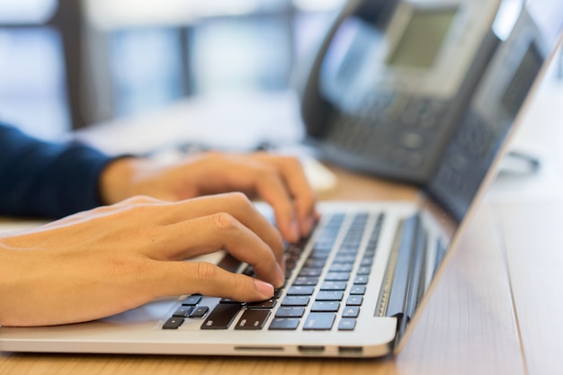 man hand typing on keyboard computer portable 