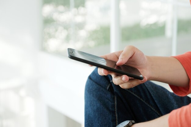 Man hand using black smart phone