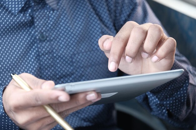 man hand using digital tablet on black background
