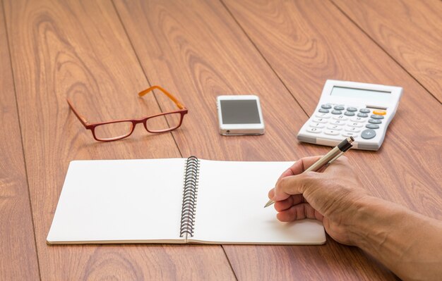 Man hand writing notebook