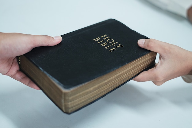 Man handed the Bible to women. Portrait Christianity