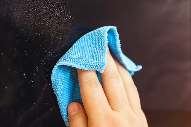 Man hands cleaning laptop screen