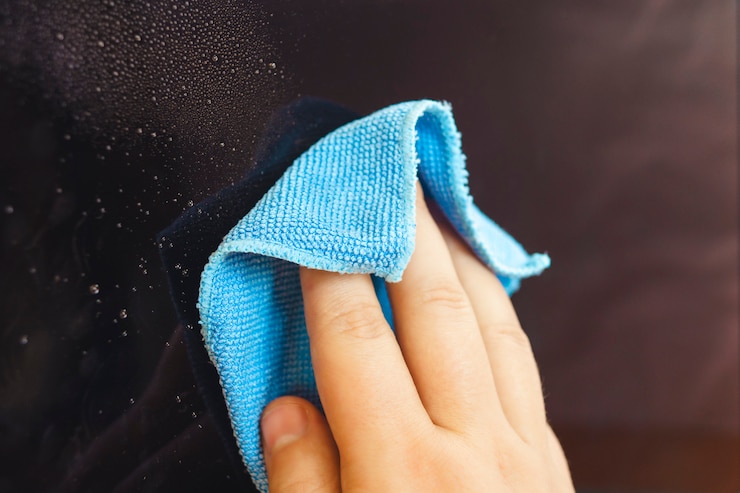 Man hands cleaning laptop screen