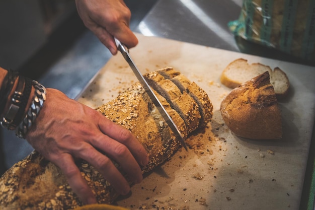 Man hands cutting bread