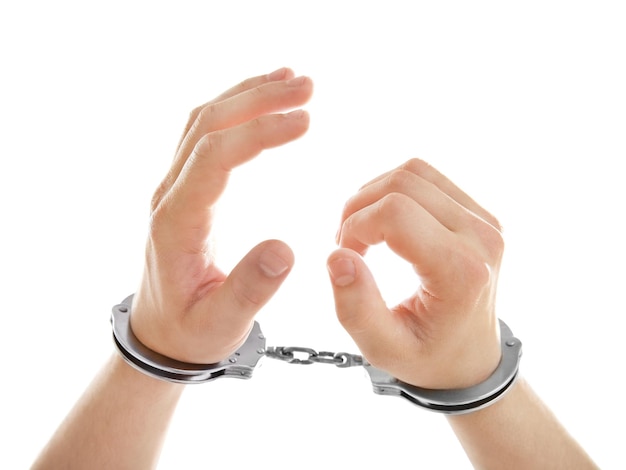 Man hands in handcuffs isolated on white