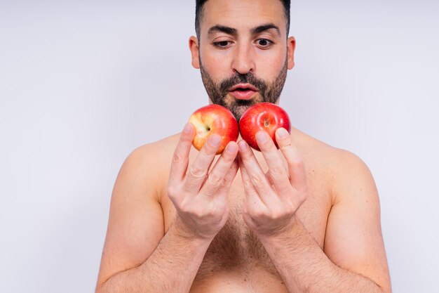 Man hands and holding apple on white background in studio for health wellness or immune support