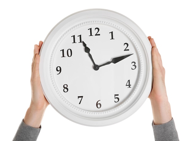 man hands holding big round clock isolated on white