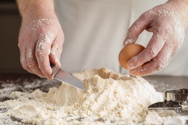 Man hands kneading a dough