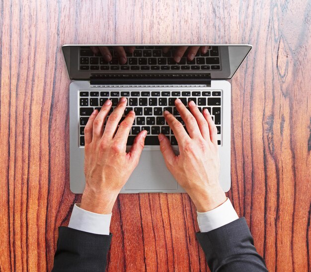 Man hands on a laptop keyboard