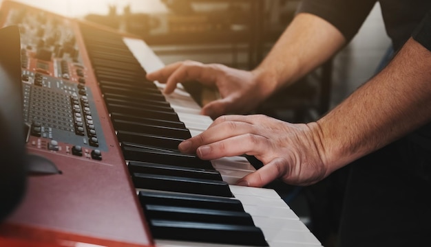 Man hands playing piano keyboard music with passion closeup musician perfomance with classical music