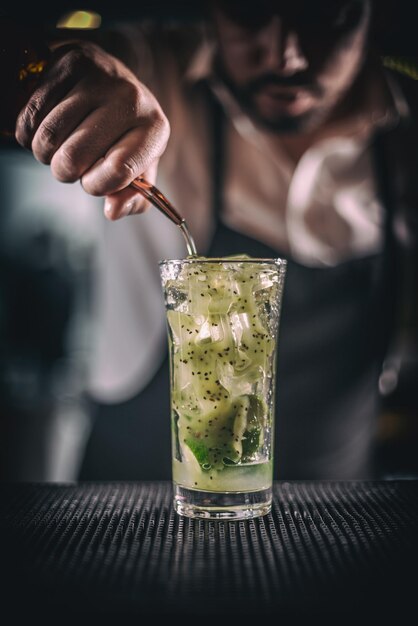 Man hands pouring alcoholic drink