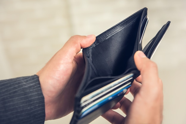 Man hands showing empty wallet with no money