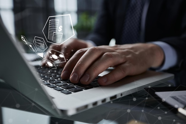 Man hands typing on laptop computer keyboard and surfing the internet on office table