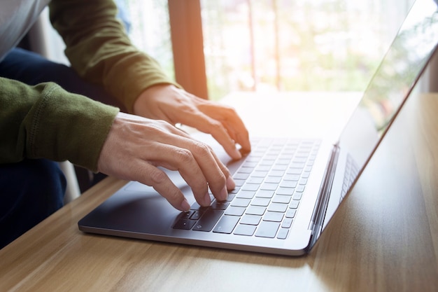 Man hands typing on laptop or computer